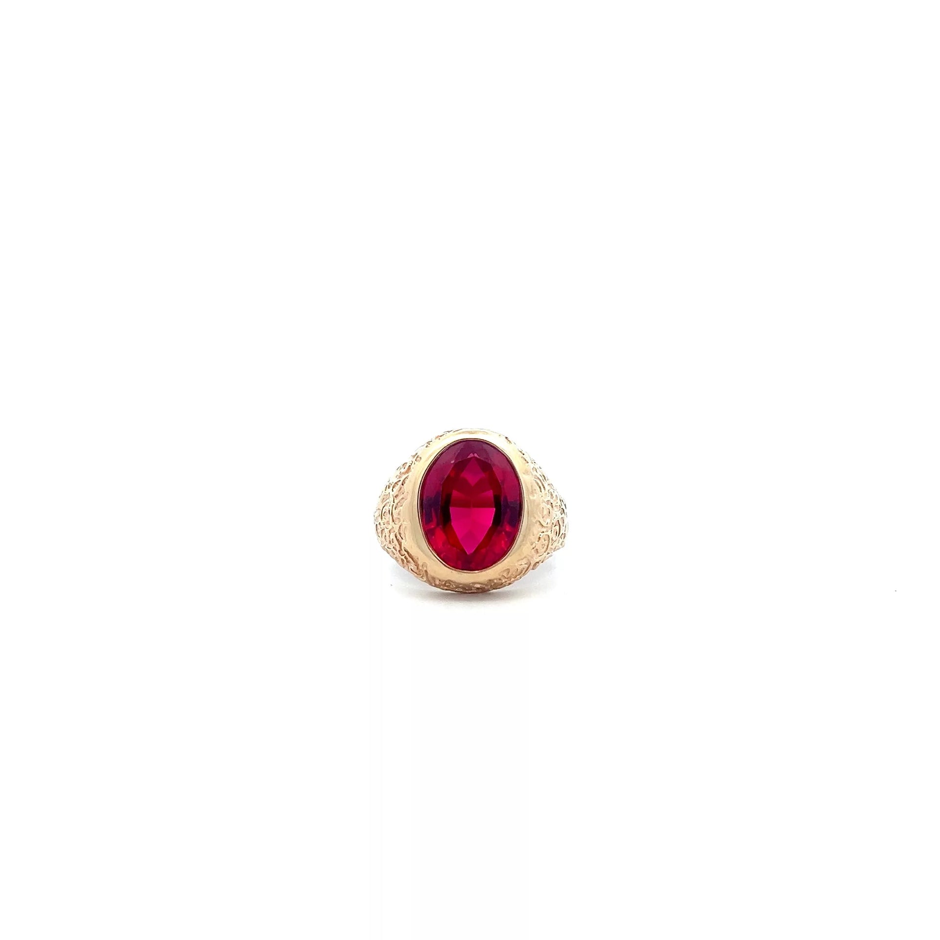 A gold ring with a ruby stone.